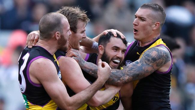 Tigers Kamdyn McIntosh, David Astbury, Shane Edwards and Dustin Martin celebrate a goal against Collingwood on Saturday. Picture: Michael Willson/AFL Media/Getty Images