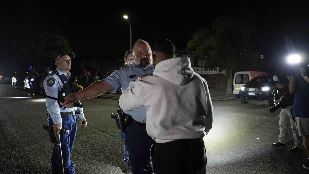 Police were confronted by an angry crowd. Picture: NCA NewsWire / Monique Harmer.