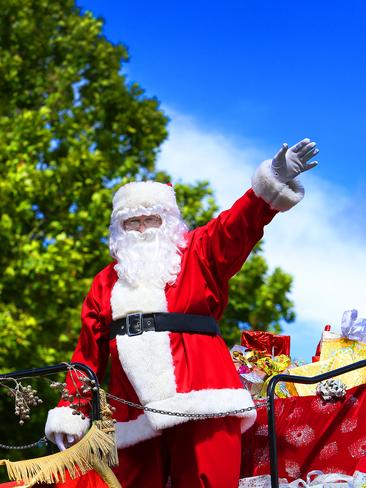 Santa waves to the crowds. Pictures: SAM ROSEWARNE