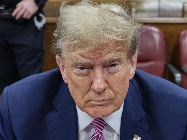 TOPSHOT - Former US President Donald Trump attends his trial for allegedly covering up hush money payments linked to extramarital affairs, at Manhattan Criminal Court in New York City on April 19, 2024. A panel of 12 jurors was sworn in on April 18, 2024, for the unprecedented criminal trial of a former US president. (Photo by Curtis Means / POOL / AFP)