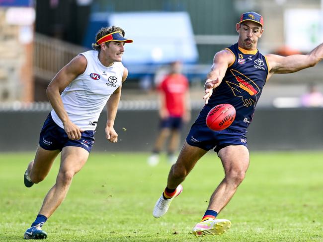 Taylor Walker of the Crows passes watched  by Josh Worrell  of the Crows  during an open training session at Norwood Oval on the Parade ,Norwood.Friday,January,17,2025.Picture Mark Brake