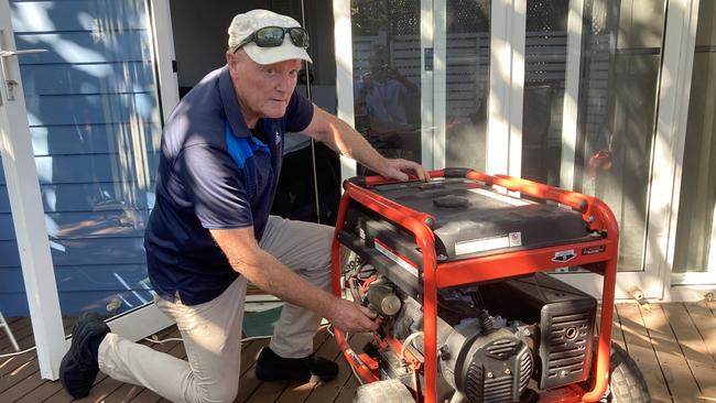 Couran Cove resident James Laverty with the generator. Picture: Greg Stolz