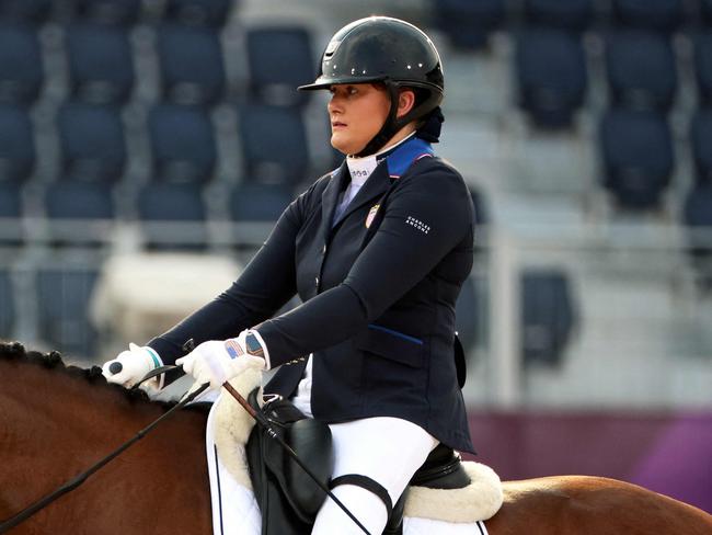 USA's Beatrice de Lavalette, a survivor of 2016 Brussles airport bombings, riding Clarc competes in the equestrian dressage individual test grade II during the Tokyo 2020 Paralympic Games at Equestrian Park in Tokyo on August 26, 2021. (Photo by Behrouz MEHRI / AFP)