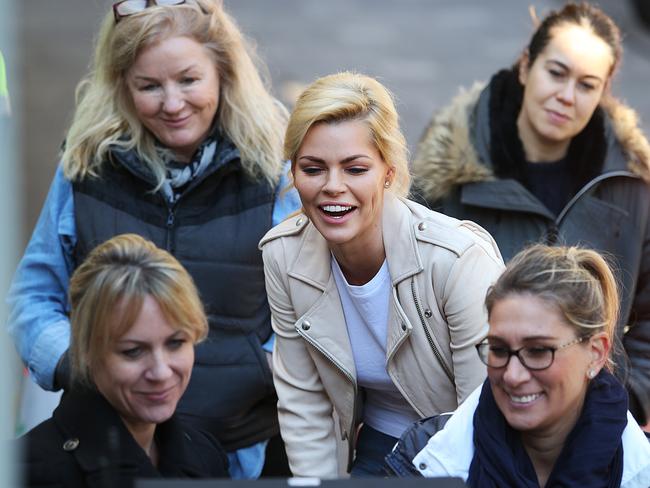 The blonde beauty watches replays with the crew. Picture: Danny Aarons