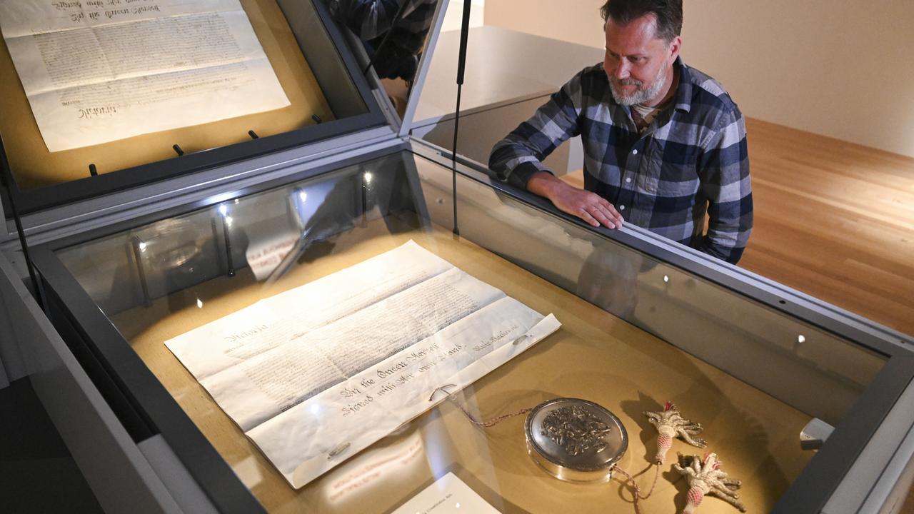 National Archives of Australia Communications officer Chris Downton with The Australian Constitution housed at National Archives of Australia in Canberra. Picture: NCA NewsWire/Martin Ollman