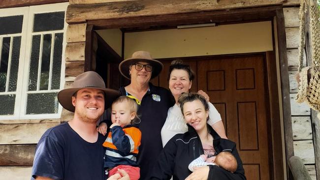 Steve and Sonia Ellery with Kurt and Tahlia Harlow, holding sons Billy and Jack, outside the entrance to Hidden Valley Cabins. Photo: Facebook