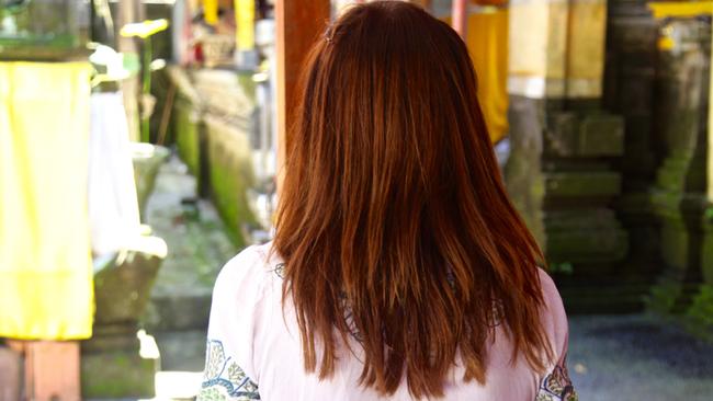 In Bali, a high priestess claims to have returned from the dead. She performs purifying ceremonies for those looking for enlightenment. Picture: Ian Lloyd Neubauer