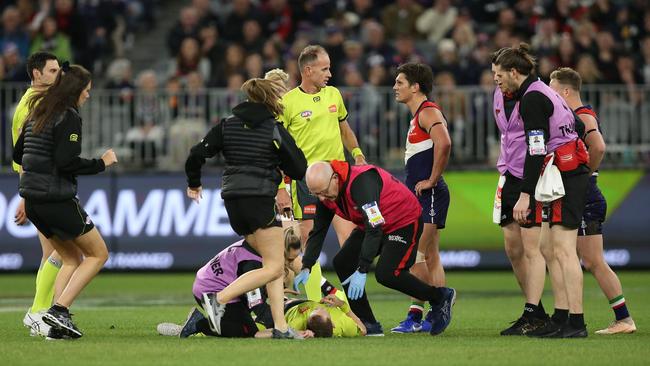 PERTH, AUSTRALIA - AUGUST 17: Umpire Alex Whetton is attended to after being hit in a collision during the round 22 AFL match between the Fremantle Dockers and the Essendon Bombers at Optus Stadium on August 17, 2019 in Perth, Australia. (Photo by Paul Kane/Getty Images)