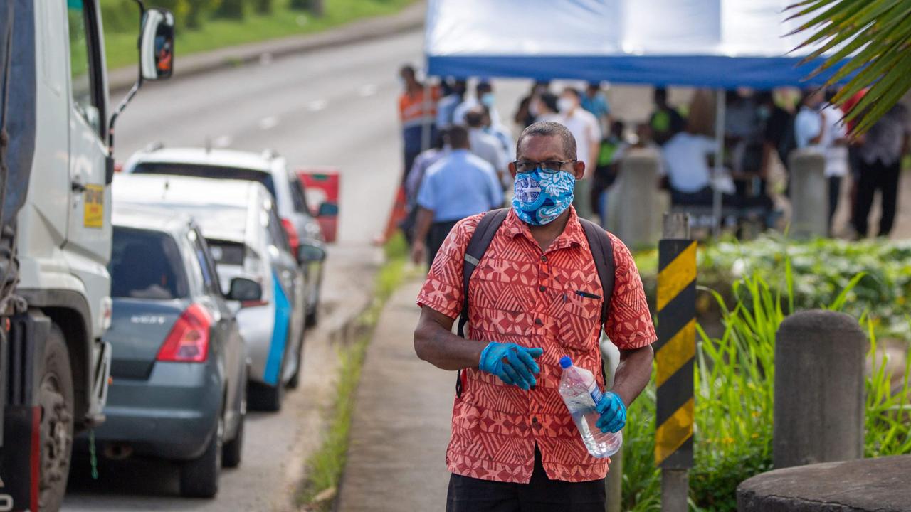 Security officers checking cars along a road in Suva after the Fijian capital entered a 14-day lockdown. Picture: Leon Lord/AFP