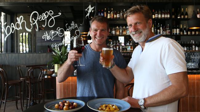 Kirra beach food institution Bread n Butter has reopened this week. Owners Jorge Mauleon and Nicholas Mesdag toast the reopening.. Picture Glenn Hampson