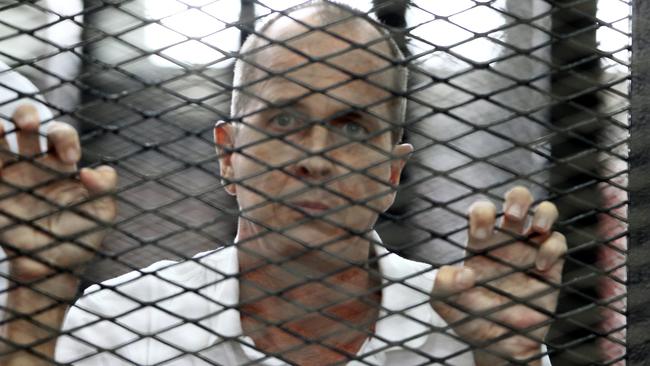 Peter Greste, inside the court’s cage in Egypt, where he was sentenced to seven years in jail on terror charges in 2014. Picture: EPA