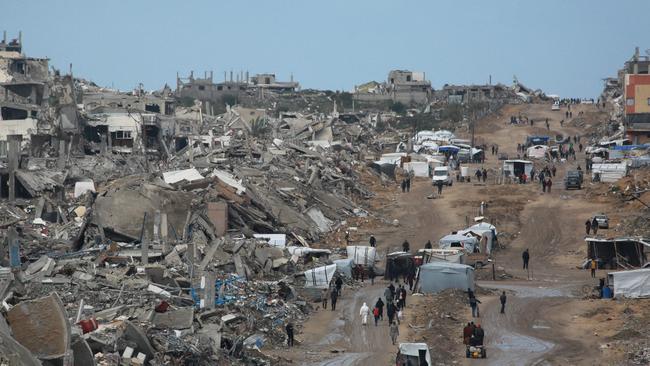 Displaced Palestinians walk through a muddy road amid the destruction in Jabalia in the northern Gaza Strip. Picture: Bashar Taleb / AFP