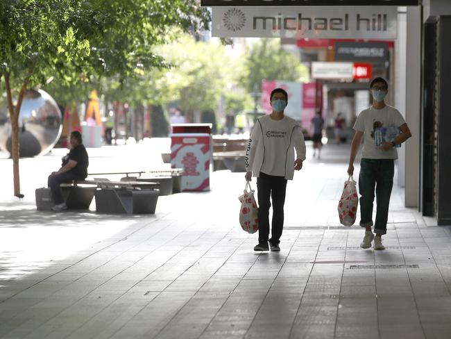 Two men wearing masks walk down a virtually-deserted Rundle Mall on Thursday morning - day one of a six-day lockdown. Picture: NCA NewsWire / Kelly Barnes