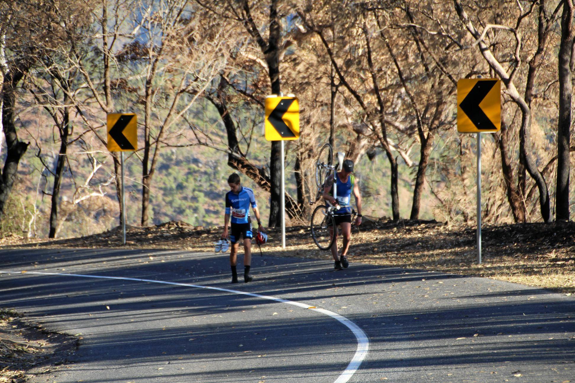 Runner Lee Pratt stops to help a cyclist finish Challenge the Mountain. Picture: Rockhampton Photography Club