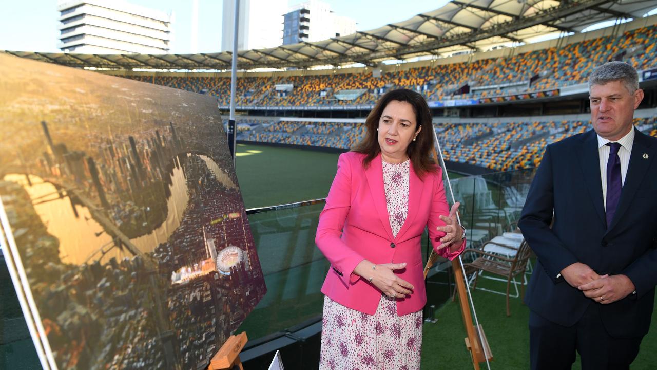 Premier Annastacia Palaszczuk and Minister for Sport Stirling Hinchliffe look at artist impressions before a press conference at the Gabba in Brisbane in April. Picture: NCA NewsWire/Dan Peled