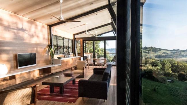 The Treehouse Byron Bay, listed on Airbnb, is an architect-designed one-bedroom steel and glass home with leafy views.