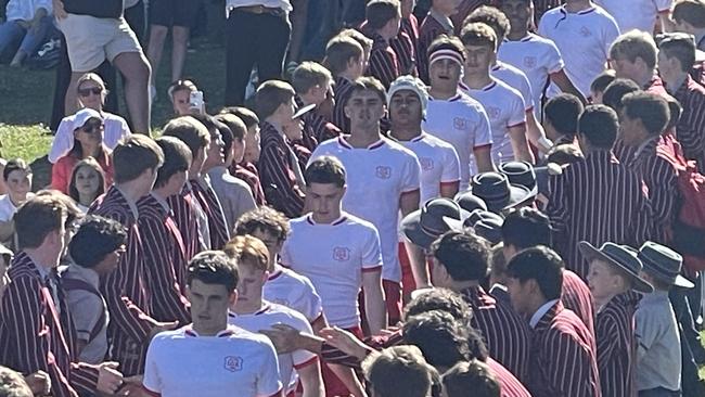 IGS players walk down a guard of honour on Old Boys Day.