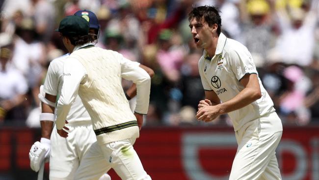 Pat Cummins celebrates the wicket of Rohit Sharma for 3 as he went on to take the first two scalps to reduce India to 2-51 on tea at day two. Picture: Martin Keep / AFP