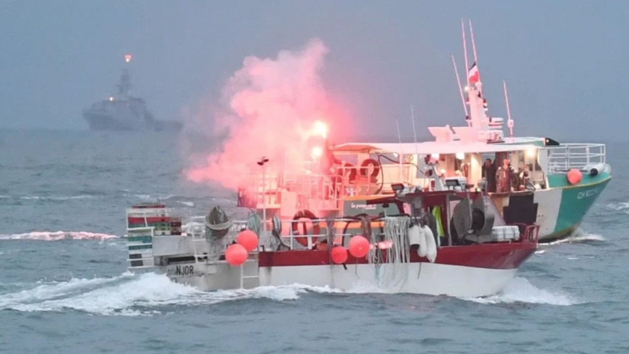 People on board the vessels were seen setting off flares as tensions continue to rise – with the Royal Navy lurking in the background. Picture: SWNS