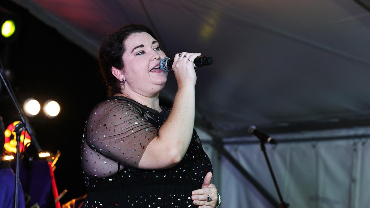 Hannah Boon sings the night's opening carol, supported by Far Northern Brass at the Cairns Churches Joy to the World Community Carols, held at the Cairns Showgrounds. Picture: Brendan Radke