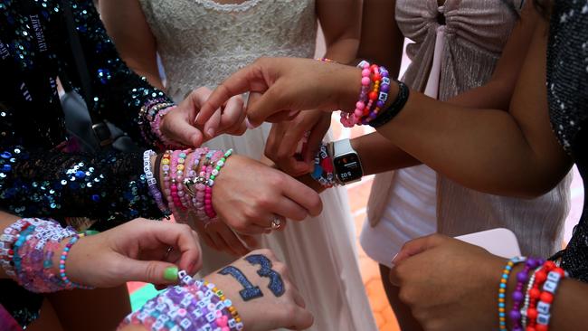 Swifties swap friendship bracelets outside Accor Stadium for Taylor Swift's first Sydney concert. Picture: Lisa Maree Williams/Getty Images