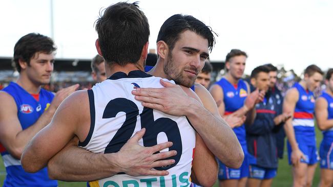 Western Bulldogs captain Easton Wood hugs retiring Adelaide champion Richard Douglas. Picture: Quinn Rooney/Getty Images.