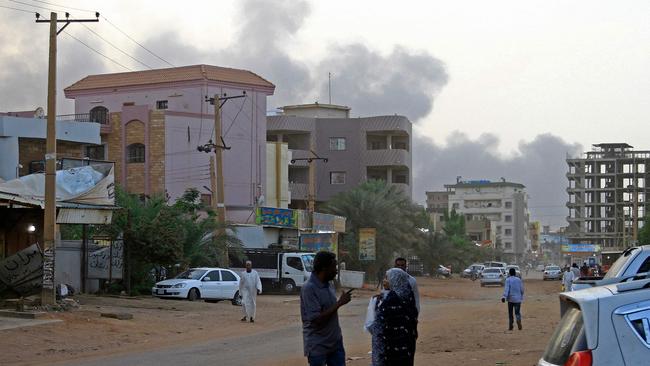 Smoke billows above residential buildings in Khartoum as fighting in Sudan rages for a second day. Picture: AFP.