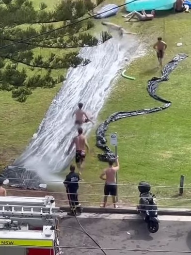 Fire and Rescue NSW help with a slip and slide at Freshwater. Picture: Creatures of Manly/Instagram