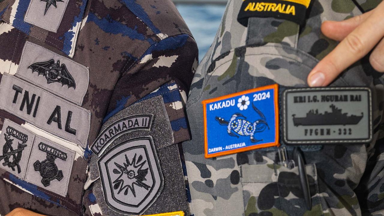 Indonesian and Australian sailors exchange patches from the exercise. Picture: Department of Defence.