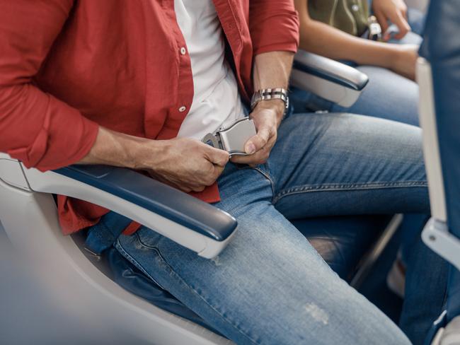 Commercial aircraft cabin with rows of seats down the aisle. morning light in the salon of the airliner. economy class