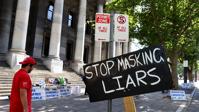 Breathless: Anti-mask protesters make their feelings known outside Parliament House. Picture: Kelly Barnes