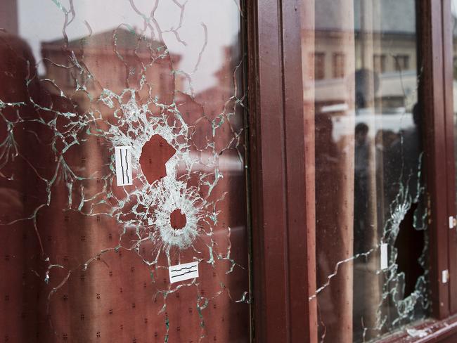 Aftermath .. bullet holes in the windows of Le Carillon Cafe. Picture: Ella Pellegrini