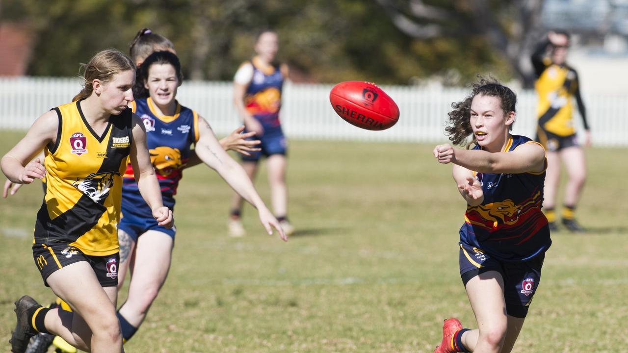 REP STAR: Phoebe Baird (right) hand balls a pass during a 2019 game for USQ Cougars. Picture: Nev Madsen