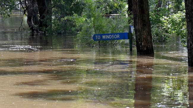 A street sign is submerged under floodwater at Cattai Ridge Road, near Hidden Valley Lane, in Glenorie, NSW. Picture: NCA NewsWire/Bianca De Marchi