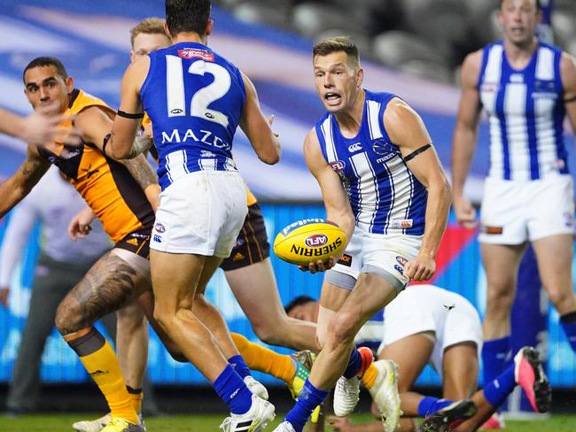 Shaun Higgins of the Kangaroos passes the ball to Jy Simpkin of the Kangaroos who misses a shot at goal in the final minutesnduring the Round 4 AFL match between the Hawthorn Hawks and the North Melbourne Kangaroos at Marvel Stadium in Melbourne, Sunday, June 28, 2020. (AAP Image/Scott Barbour)