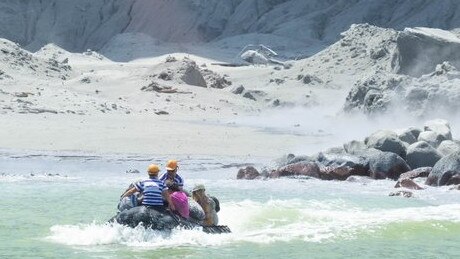 White Island Tour operators rescuing people, 12 to 14 minutes after the eruption. A helicopter is visible in the background. Picture: Michael Schade