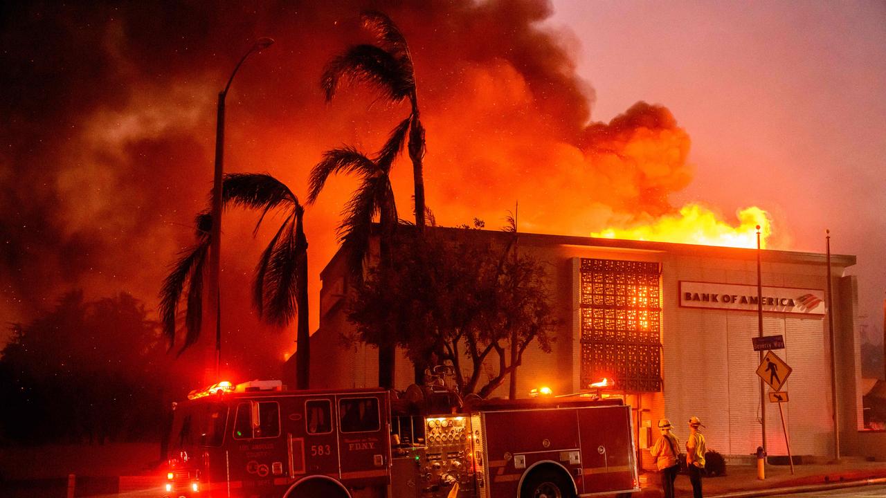 A Bank of America is fully engulfed in flames along Lake Ave. during the Eaton fire in the Altadena area of Los Angeles county. (Photo by JOSH EDELSON / AFP)