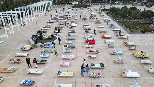 An aerial view shows the ‘Empty Beds’ installation consisting of 241 beds representing the number of hostages taken by Palestinian militants during the October 7 attack, outside the Charles Bronfman Auditorium at HaBima Square in Tel Aviv. Picture: AFP