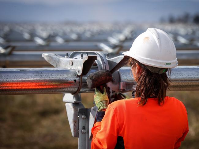 A worker checks newly constructed metal frames for photovoltaic modules at a solar farm on the outskirts of Gunnedah, New South Wales, Australia, on Friday, April 16, 2021. Most Australians would prefer investment inÃÂ clean energyÃÂ to help lift the economy out of its Covid-induced recession to the governments plan for a "gas-fired" recovery. Photographer: David Gray/Bloomberg via Getty Images