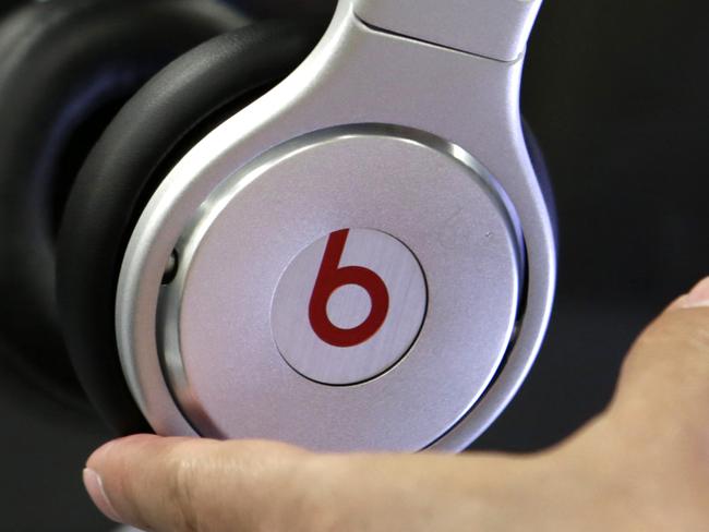 A customer holds a pair a beats headphones at a Best Buy store in Hialeah, Fla. on Thursday, May 29, 2014. On Wednesday, May 28, 2014, Apple announced it acquired Beats Electronics, founded by rapper Dr. Dre and Jimmy Iovine. (AP Photo/Alan Diaz)