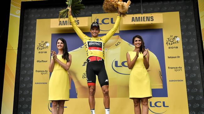 Belgium's Greg Van Avermaet, wearing the overall leader's yellow jersey, celebrates on the podium after the eighth stage of the 105th edition of the Tour de France cycling race between Dreux and Amiens, northern France, on July 14, 2018. / AFP PHOTO / Marco BERTORELLO