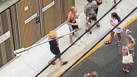 Another youth ripped up a street sign and appeared to want to use it to force entry into the building.