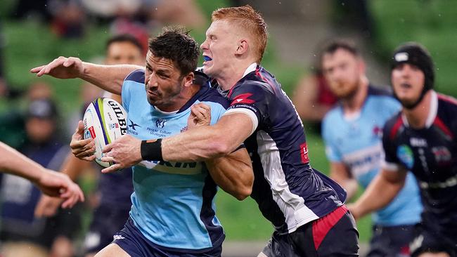 Jake Gordon of the Waratahs is tackled by Campbell Magnay of the Rebels during the Round 3 Super Rugby match between the Melbourne Rebels and NSW Waratahs at AAMI Park in Melbourne, Friday, February 14, 2020. (AAP Image/Scott Barbour) NO ARCHIVING, EDITORIAL USE ONLY