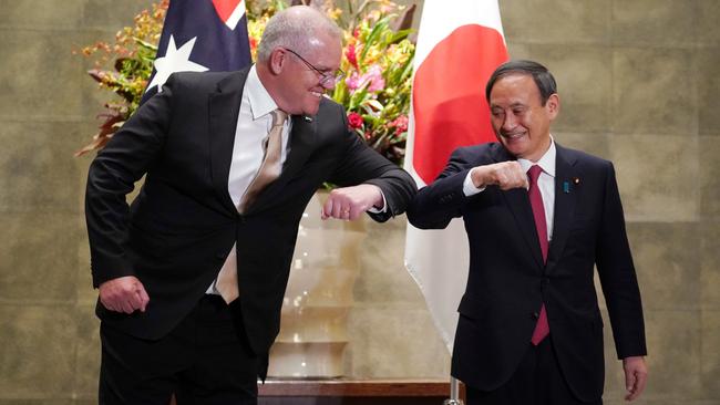 Scott Morrison greets Yoshihide Suga at the Japanese Prime Minister’s official residence in Tokyo on Tuesday. Picture: Reuters