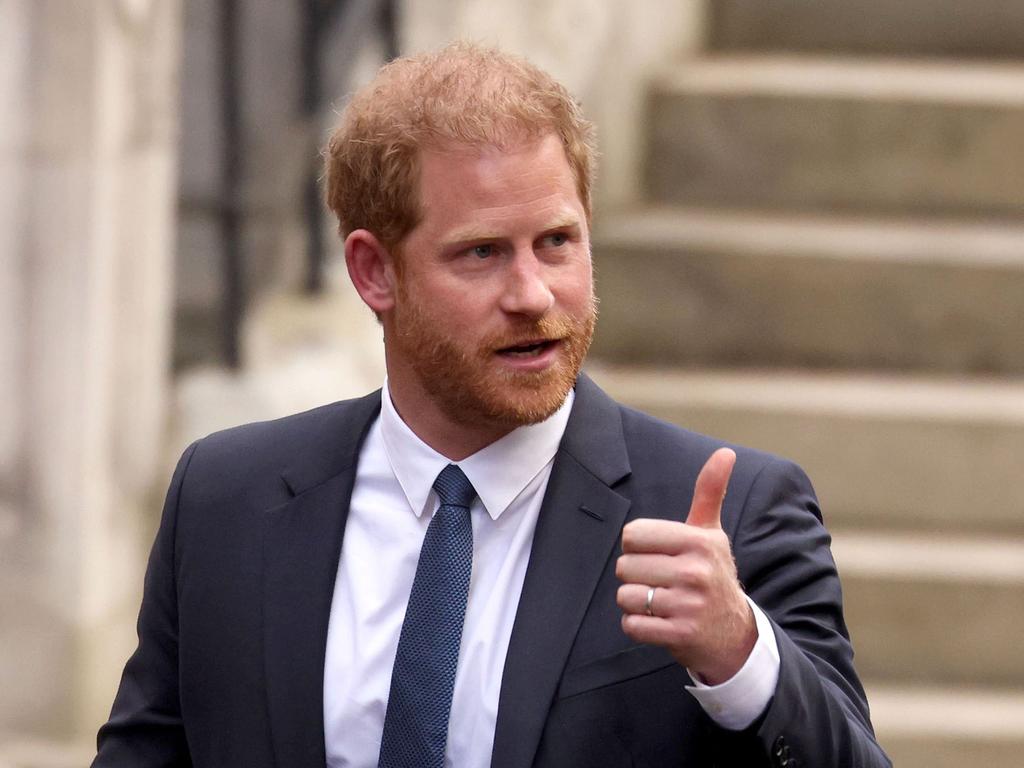 Prince Harry gives the thumbs up outside the court. Picture: Getty Images