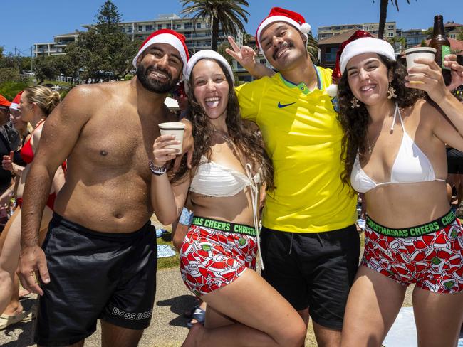 Andre Tanure Brazil 34, Ana Machado Portugal 27, Victor Oliveira Brazil 28 and Tatiana Martins Portugal 23 pose for a photo at Bronte Beach on Christmas Day. Picture: Daily Telegraph/ Monique Harmer