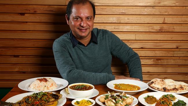 Mohammed Abid with Bengali dishes fusca, black fish, halim, vorta and hilsha fish curry from his restaurant Khushboo Sweets &amp; Restaurant in Lakemba. Picture: Jonathan Ng