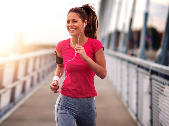 Young woman jogging outdoors on bridge. Concept of healthy lifestyle.