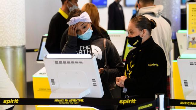 A passenger checks in for a flight at Los Angeles International Airport. America should prepare for a ‘surge upon a surge’ in coronavirus cases after the Thanksgiving holiday. Picture: AFP