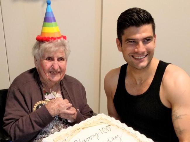 Elva Larsen on her 100th birthday with stripper "Johnny Star" and her birthday cake.